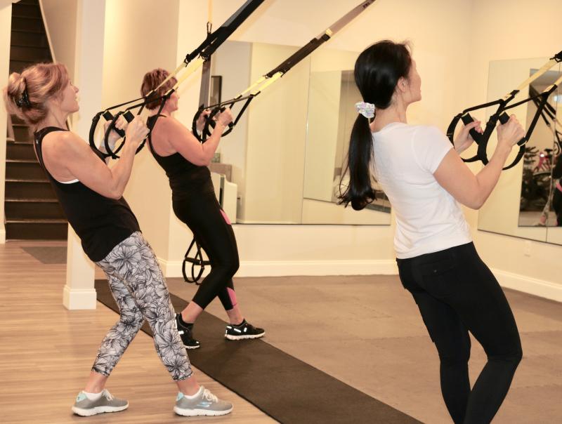 Using TRX suspension straps, gravity and their body weight for a challenging, joint-friendly workout at Rehoboth Strength and Balance are (l-r) Raquel Maynes, Kelly Phillips and Van Roland. SUBMITTED PHOTO